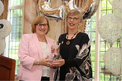 VP of Community Relations Jeanne Braham (l) presents the Distinquished Service Award to DiAnne Arbour (JBWS Executive Director from 1980- 1997).