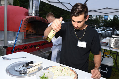 Zach Kahn making pizza for 900 Degree Brick Oven Pizza